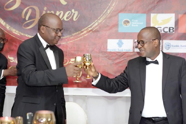 Dr Ernest Addison (left), Governor, BoG, having a toast with his deputy, Dr Maxwell Opoku-Afari