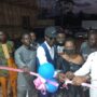 TiC flanked by Mr.Okyere-Agyekum (first right), Mr.Ofosu (first left) cut the ribbon to officially open the facility