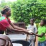 A Miss Tourism Ghana Princess handing out food to some of the orphans