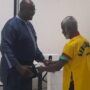 • Dr Spio-Gabrah being decorated with the Honorary Black Belt by Reggie Gwira