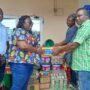 Madam Frimpong (left) presenting the items to the CEO of the Foundation (left)