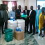 • Pastor Dr. Arloo (fourth from right) receiving the items from Mr. Agbo while some church elders look on