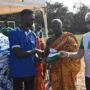 Andrews Gyawu (2nd from left), receiving his cheque from Mr. Barre whilst shaking hands with Awulae Amihere Kpinyili II. With them is Prey Mensah II, Adeshehene of Nsein (left)
