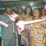 • Mr. Martin Adu-Owusu (right), MD, New Times Corporation, being supported by Mr. Emmanuel Amponsah (2nd left), Editor of The Spectator, Madam Dakoa Newman (3rd left), MP, Okaikoi South, and Madam Lydia Naa Kowah Quaye (4th left), Queen of Kaneshie Market Complex, to cut the ribbon