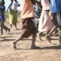 Pupils walk bare foot to school