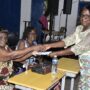 • Mrs Constance Mante, a retiree presenting a gift to Ms Clottey as Ms Diana Agyei, a senior citizen looks on