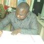 Mr Albert Dwumfour signing the book of Condolence