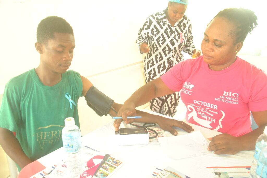 Health professional checking  the blood pressure of a staff member of GIHOC