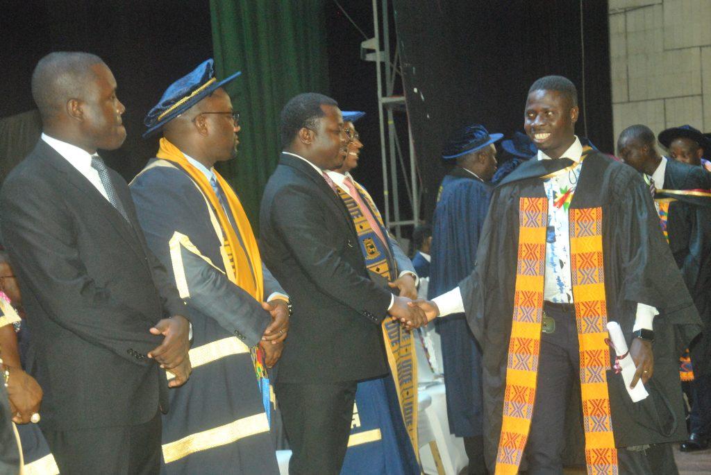 Rev.Ntim Fordjour third from left] congratulating a student with him prof.Amevi Acakpovi and others.