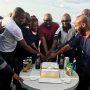 • Kutsoati (middle) being assisted by other military officers onboard to cut the birthday cake.